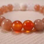 Detailed shot of porous lava stone contrasted with smooth, glossy gemstone textures.