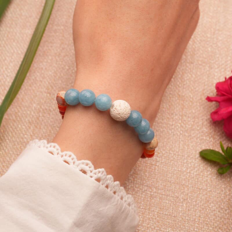 Model wearing the bracelet with natural gemstone beads in a casual outfit setting.