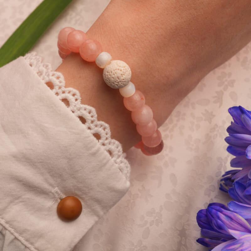 The bracelet worn on the wrist, highlighting its calming pastel tones and natural gemstone textures.