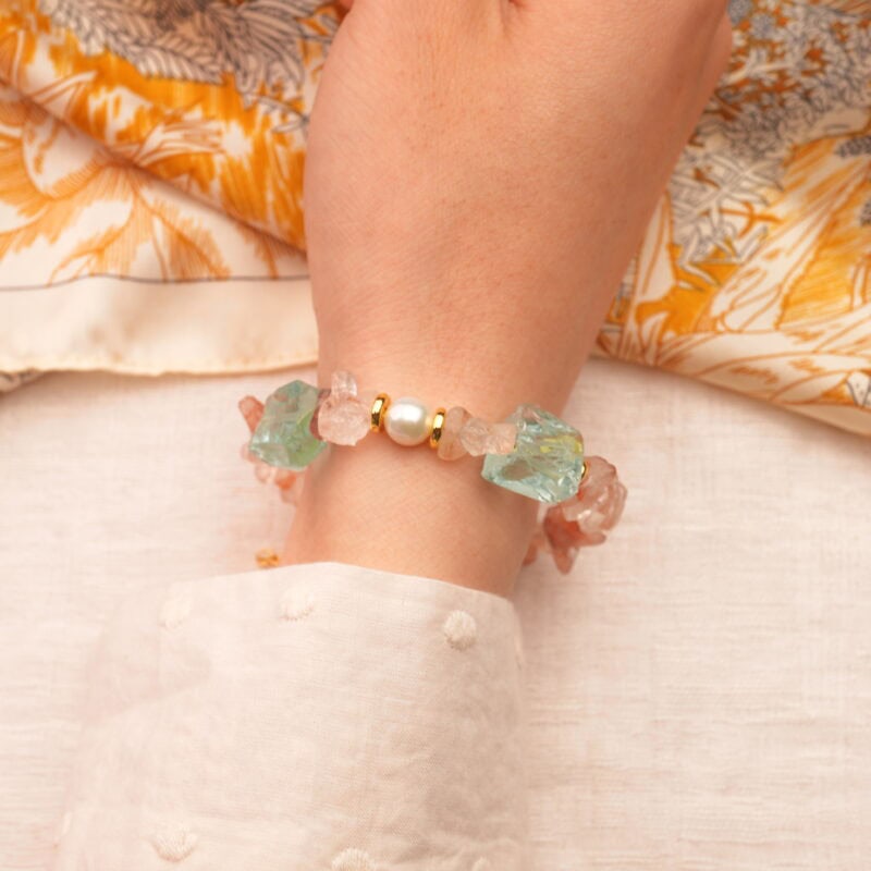 The Leo bracelet on wrist, showcasing the warm tones of Fire Quartz and the soft shine of Pearl and Aquamarine.