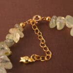 Close-up shot of the prehnite bead, revealing its soft green hue and natural internal textures.