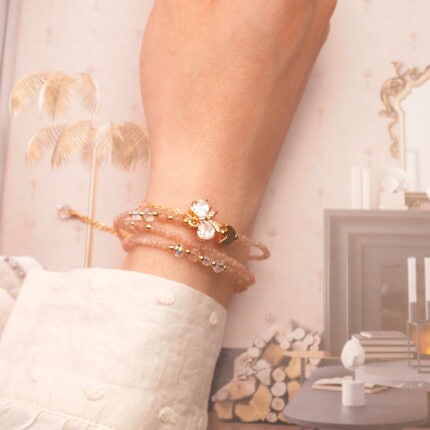 Rose quartz bracelet wrapped around the wrist, highlighting its gentle pink hue and soft energy.