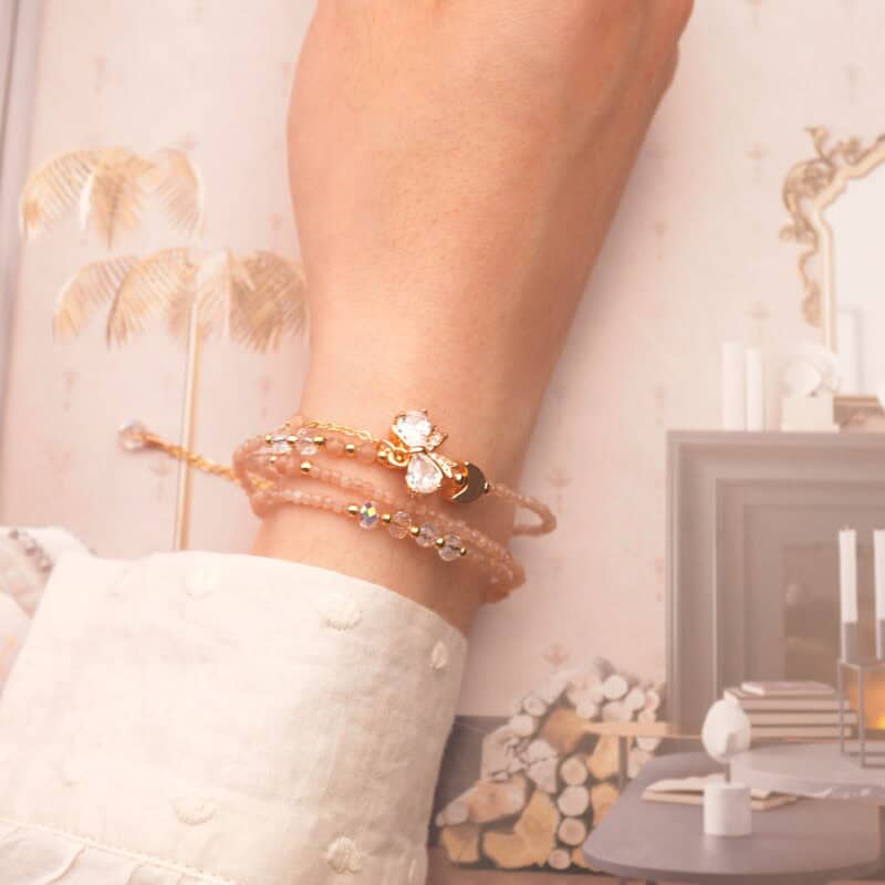 Rose quartz bracelet wrapped around the wrist, highlighting its gentle pink hue and soft energy.