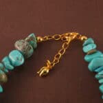Close-up showing the texture and subtle luster of turquoise, pearl, and aquamarine beads.