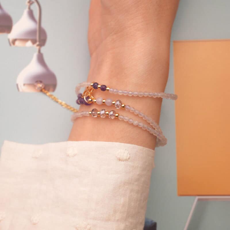 The amethyst bracelet wrapped three times around the wrist, displaying its rich purple tones and calming presence.