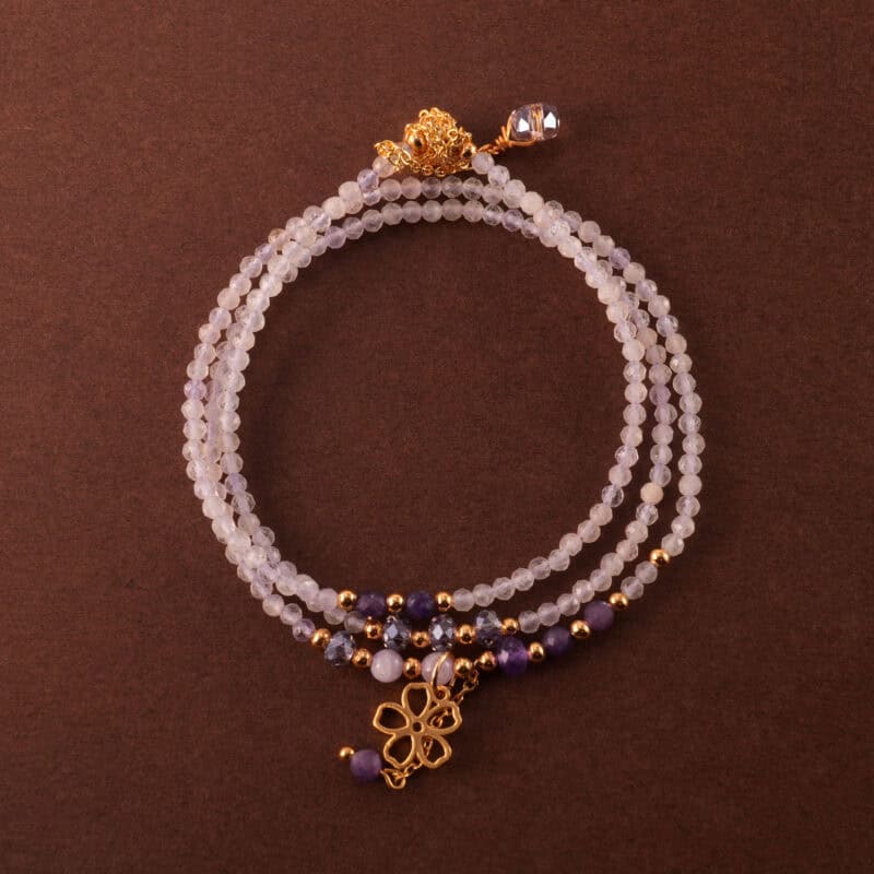 Multi-use necklace made with lavender and Uruguayan amethyst beads, shown coiled in a soft, elegant layout.