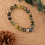 Moss agate bracelet in natural light showing green inclusions.