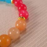 Close-up of multi-gemstone bracelet featuring colorful beads.