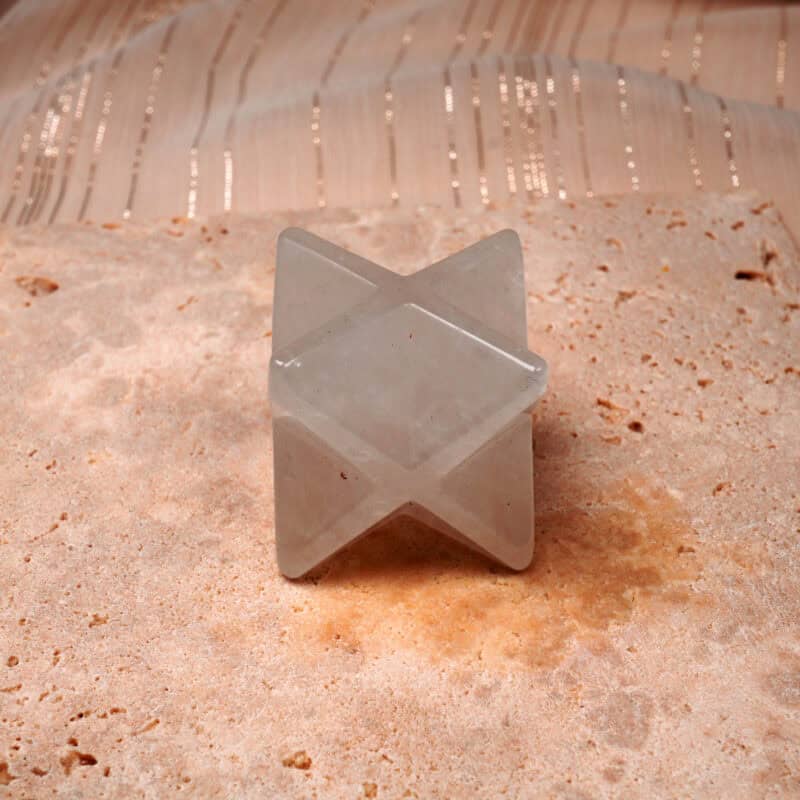 Natural clear quartz Merkaba ornament displayed clearly on a plain background.