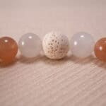 Close-up of peach moonstone and chalcedony bracelet with lava stone.