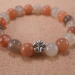 Close-up of peach moonstone and white agate bracelet with S925 silver accents.