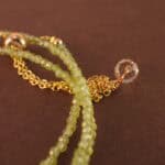 Close-up of prehnite beads showing soft green hue, natural inclusions, and smooth finish.