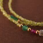 Close-up of prehnite beads showing soft green hue, natural inclusions, and smooth finish.