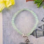 Prehnite bracelet in daylight showing pale green hue.