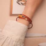 The bracelet wrapped three times around the wrist, blending the deep blue of lapis lazuli with the rich red of agate for a striking stacked look.