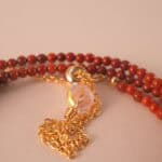 Close-up of red agate and lapis lazuli beads, showing polished surfaces and natural textures.