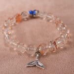 Close-up of rutilated quartz bracelet with golden needle inclusions and S925 silver.