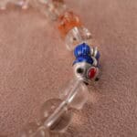 Close-up of rutilated quartz bracelet with golden needle inclusions and S925 silver.