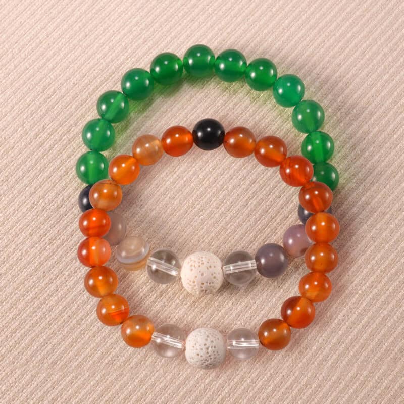 Main image of stacked agate and lava bracelets in earthy tones.