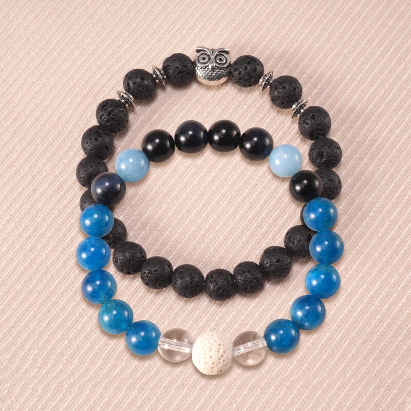 Main image of stacked bracelets with black and blue gemstones.
