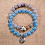 Main product image showing stacked blue and cream chalcedony bracelets.