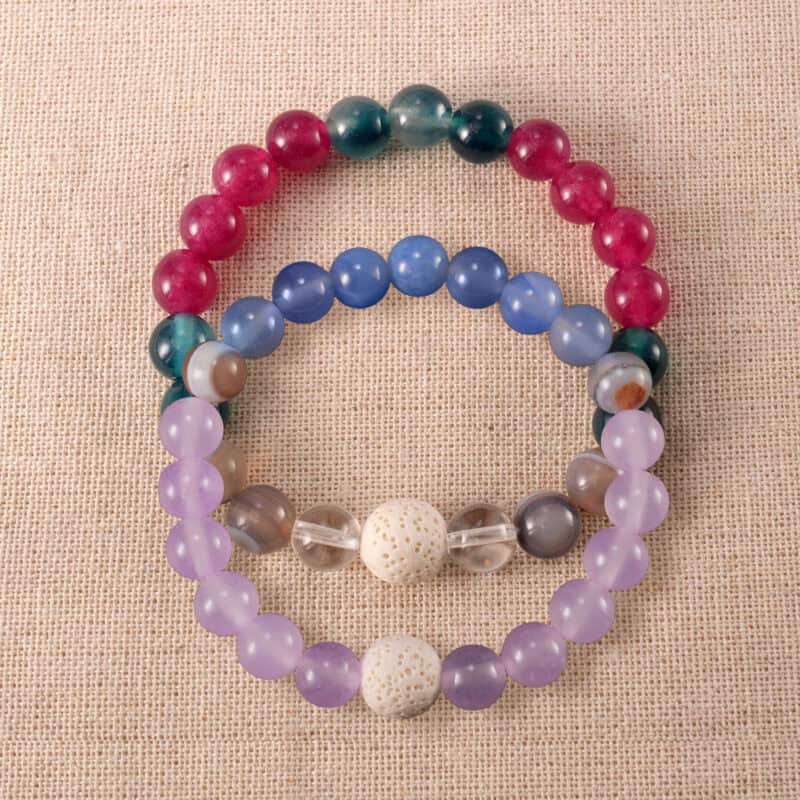 Main image of stacked bracelets with cool-toned gemstone mix.