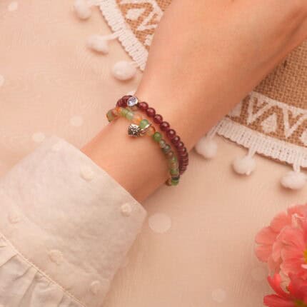 Model wearing gemstone stack in vibrant contrast.
