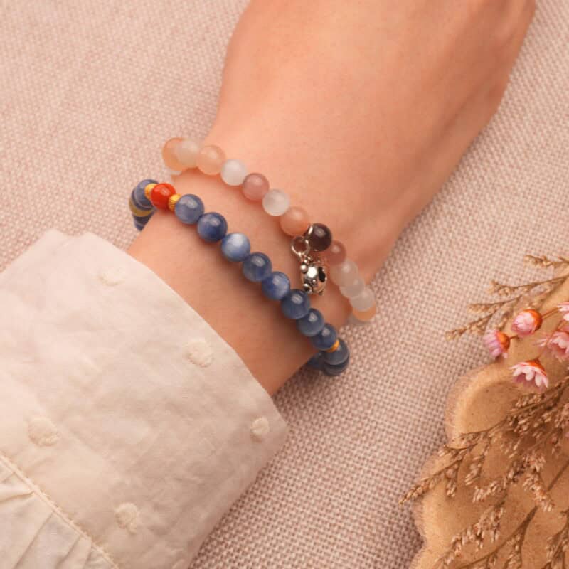 Model wearing kyanite and strawberry quartz bracelets.