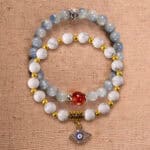 Main image of stacked bracelets in kyanite, red agate, and howlite.