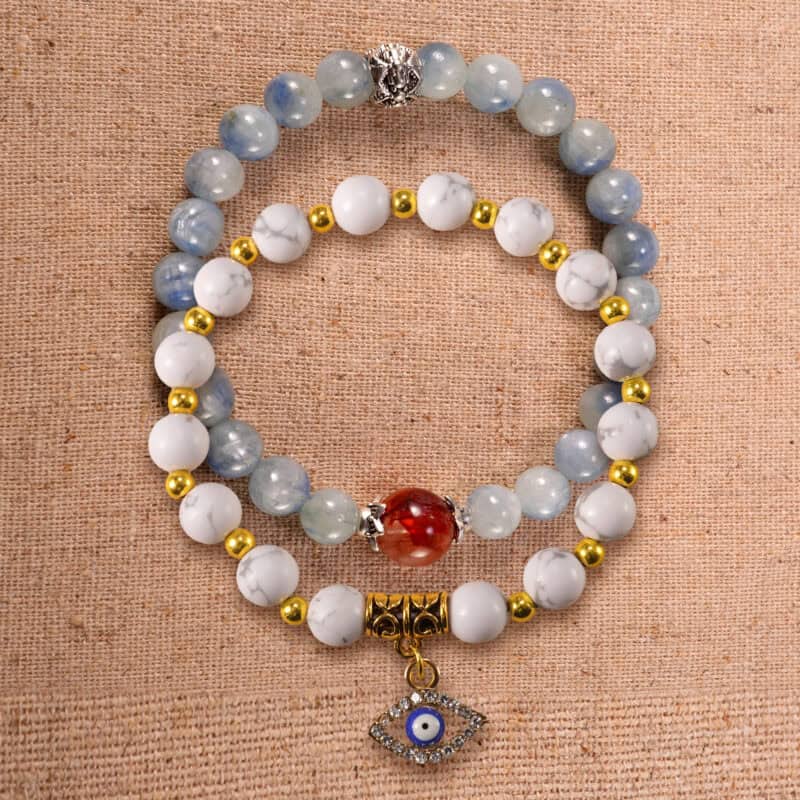 Main image of stacked bracelets in kyanite, red agate, and howlite.