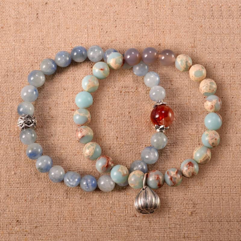 Main image of stacked bracelets in vibrant red, blue, and warm beige.