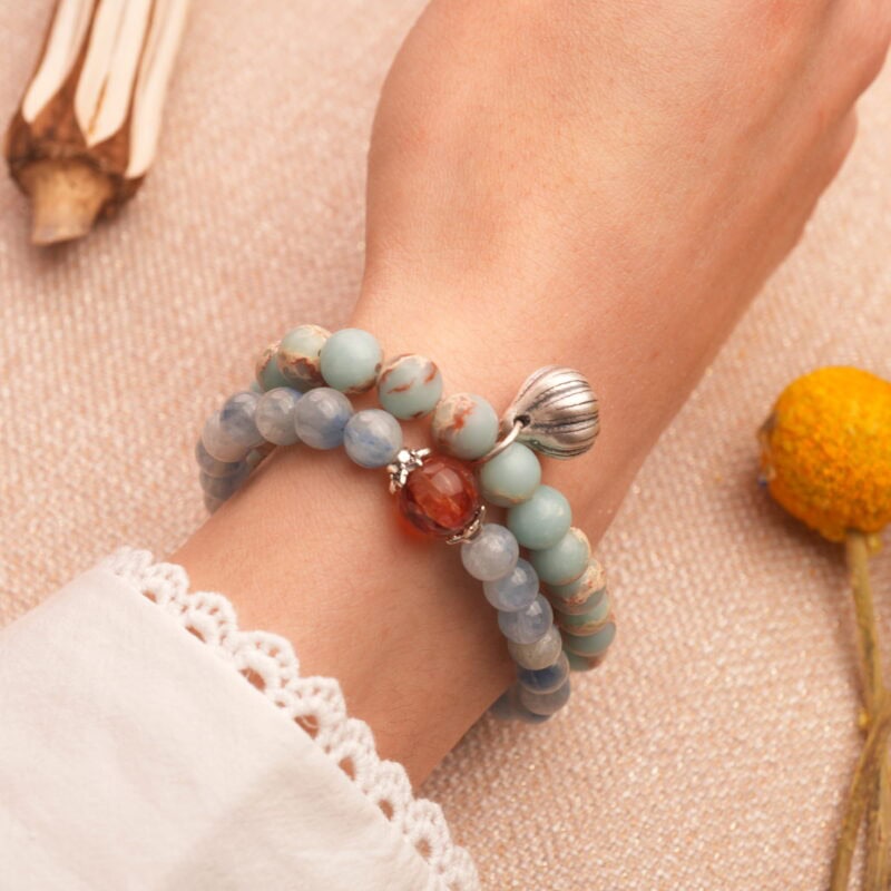 Model wearing gemstone stack featuring bold and grounded colors.