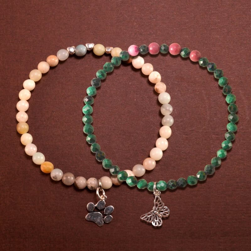 Main image of stacked bracelets in malachite green and pastel tones.