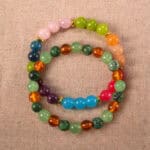 Main image of stacked gemstone bracelets with vivid color combinations.