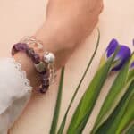 Model wearing purple phantom and clear quartz bracelets stacked together.