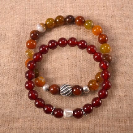 Main image of stacked red agate bracelets in deep and rich tones.
