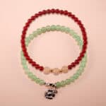 Main image of stacked red agate, white chalcedony and prehnite bracelets.
