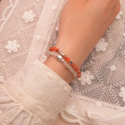 Model wearing red and white gemstone stack.