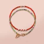 Close-up of red agate bracelet with smooth beads and deep red color.