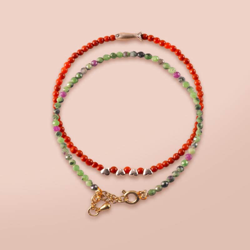 Close-up of red agate bracelet with smooth beads and deep red color.