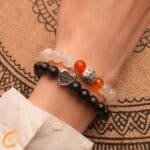 Model wearing bold and bright gemstone stack with silver accents.