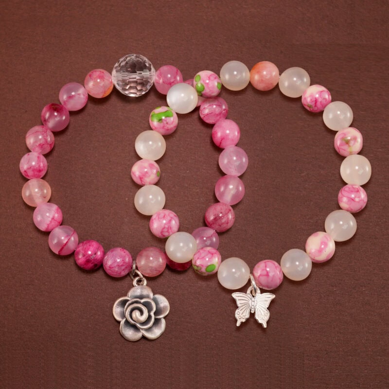 Main image showing stacked bracelets: white chalcedony mix and pink quartz.