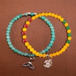 Main image of stacked bracelets in warm yellow and cool mint tones.