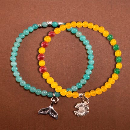 Main image of stacked bracelets in warm yellow and cool mint tones.