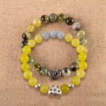 Main image of stacked bracelets: yellow jade, blue chalcedony, and moss agate.