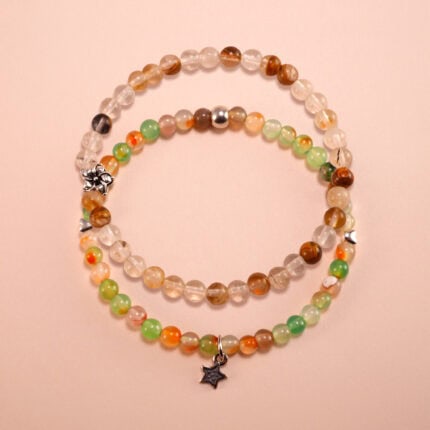 Main image of stacked yellow, white, and green chalcedony bracelets.