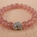 Close-up of strawberry quartz bracelet with S925 silver detail.