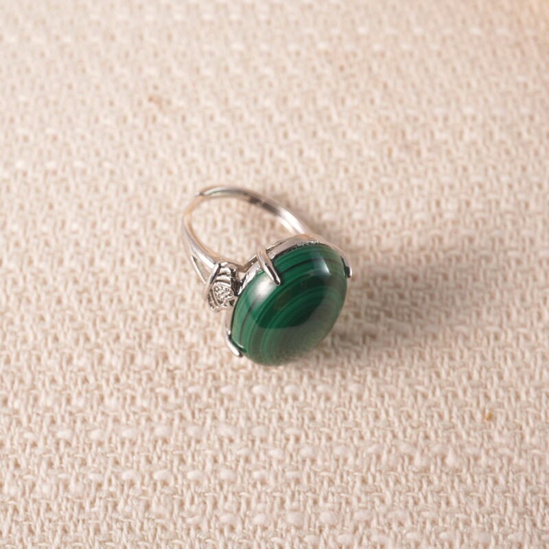 Adjustable open malachite ring displayed on a neutral background, showcasing its rich green hues and sleek silver band.