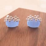 Close-up of the blue cat’s eye studs highlighting their natural glow and smooth texture.