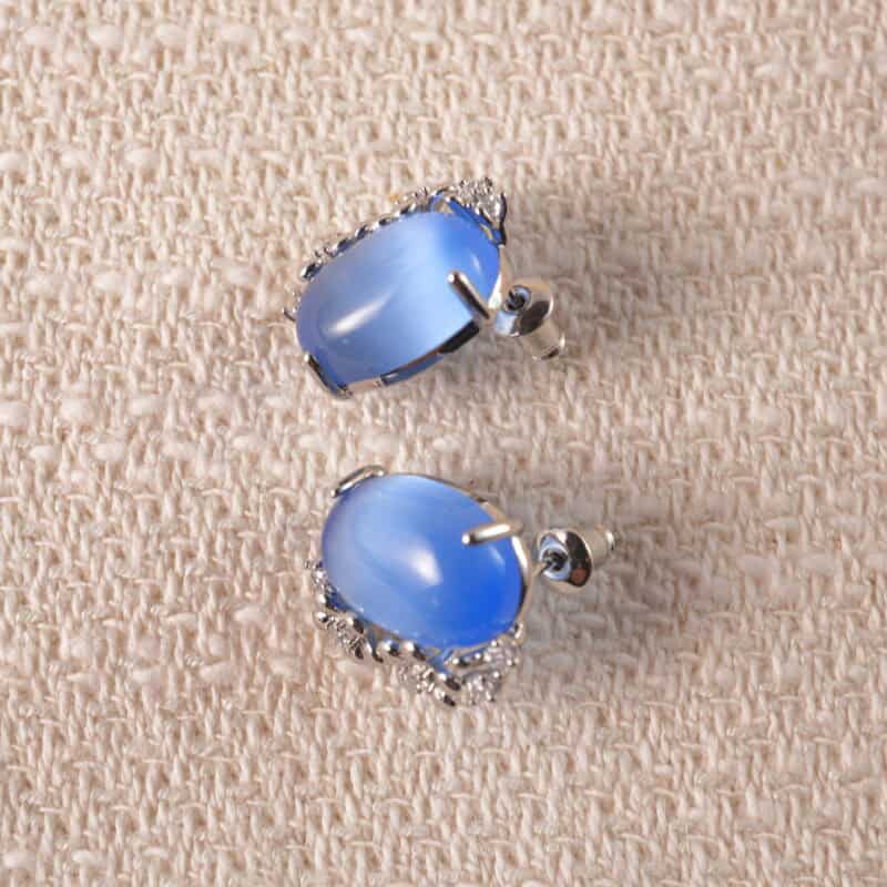 A pair of blue cat’s eye stud earrings with a minimalist design and soft luster.